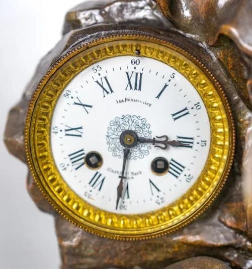 Three piece patinated metal clock set  Moreau 'Le Commerce'