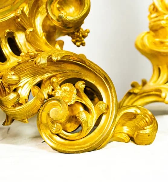 Fire-gilded three-piece clock set with rococo-style cherub and satyr depictions