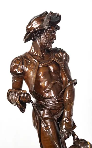 Bronze sculpture of a medieval hunter with dogs