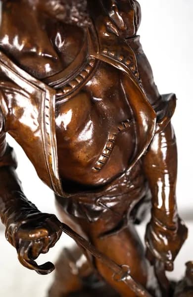 Bronze sculpture of a medieval hunter with dogs
