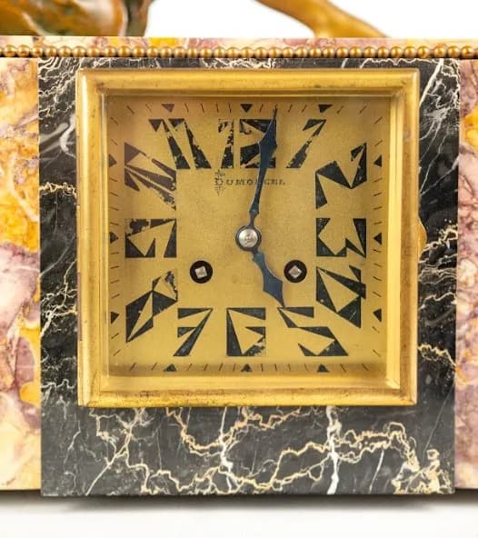 Art Deco mantel clock with a pair of vases